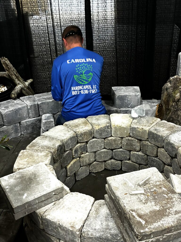 Kenny Burns of Carolina Hardscapes building a retaining wall at the Home Show